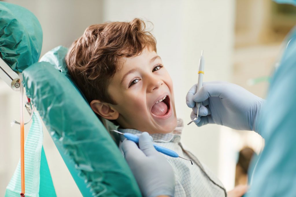 Young boy getting his teeth examined