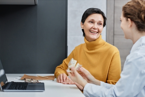 Smiling,Mature,Woman,Talking,To,Dentist,In,Dental